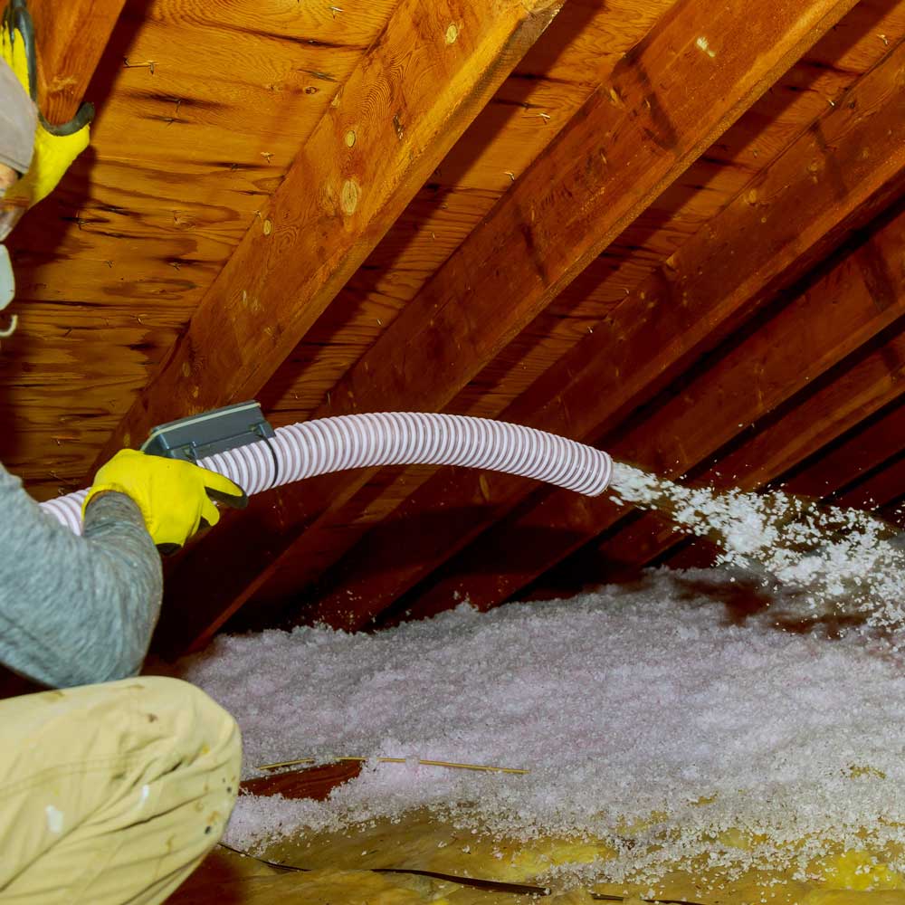 technician-spraying-blown-fiberglass-insulation-be-2023-11-27-05-25-38-utcFN